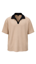 A short-sleeve drop shoulder shirt in beige with a contrasting black collar and split placket, shown against a plain white background.
